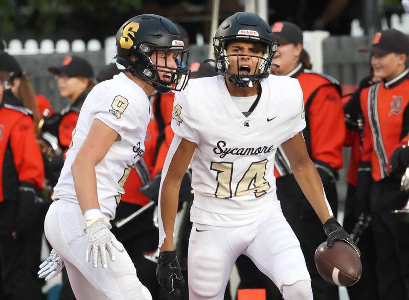 Sycamore's Josiah Mitchell (right) celebrates his opening kickoff return for a touchdown with Caden O’Donnell Friday, Aug. 30, 2024, during the FNBO Challenge at Huskie Stadium at Northern Illinois University.