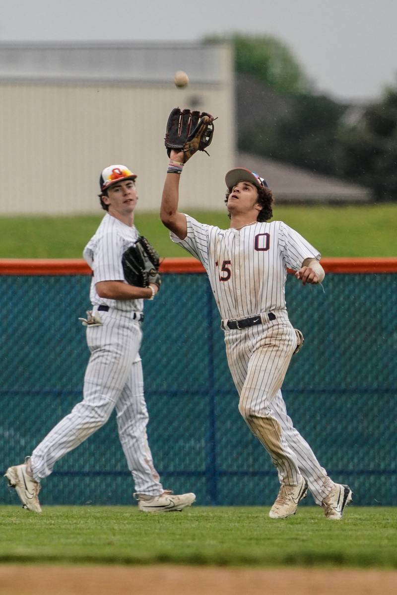 Oswego’s Donovan Williams (15) catches a fly ball for an out against Oswego East during a baseball game at Oswego High School on Monday, May 13, 2024.