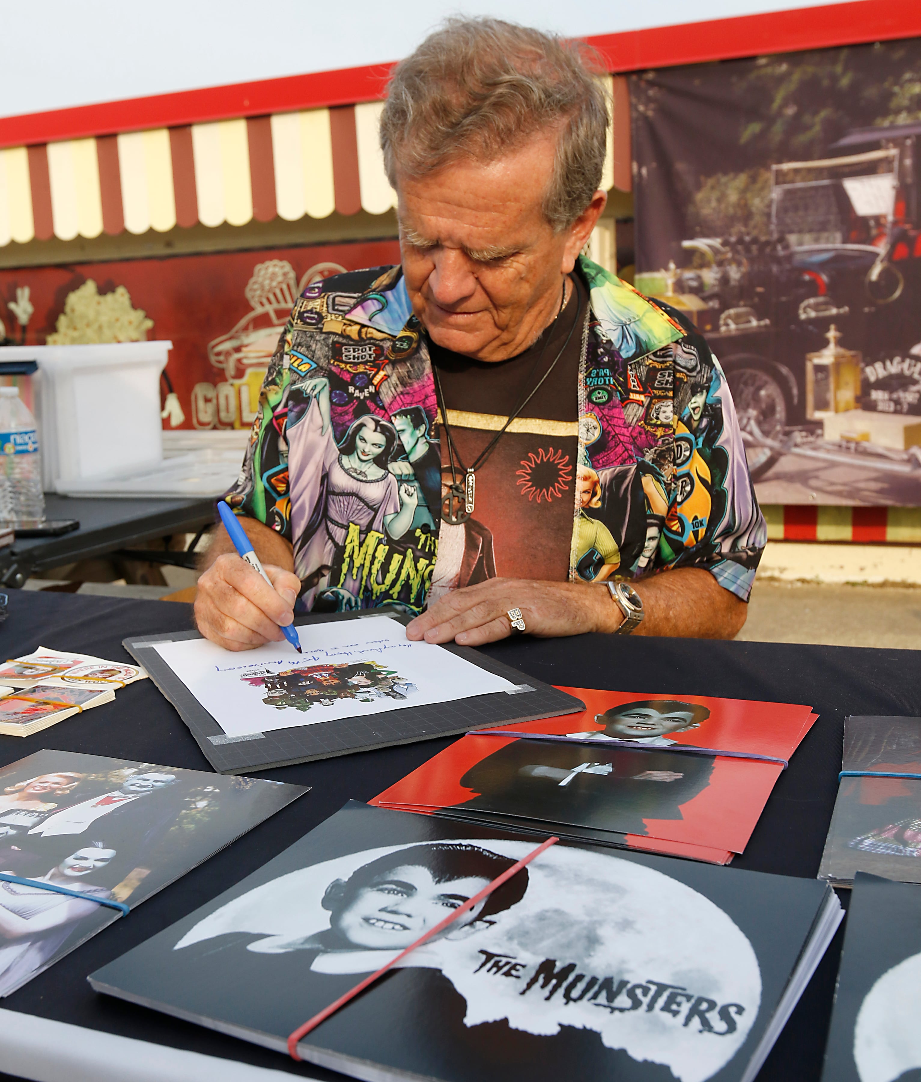 Butch Patrick, who played Eddie Munster on the 1960s show “The Munsters” signs autographs, Wednesday, Aug. 14, 2024, during an appearance at the McHenry Outdoor Theater.