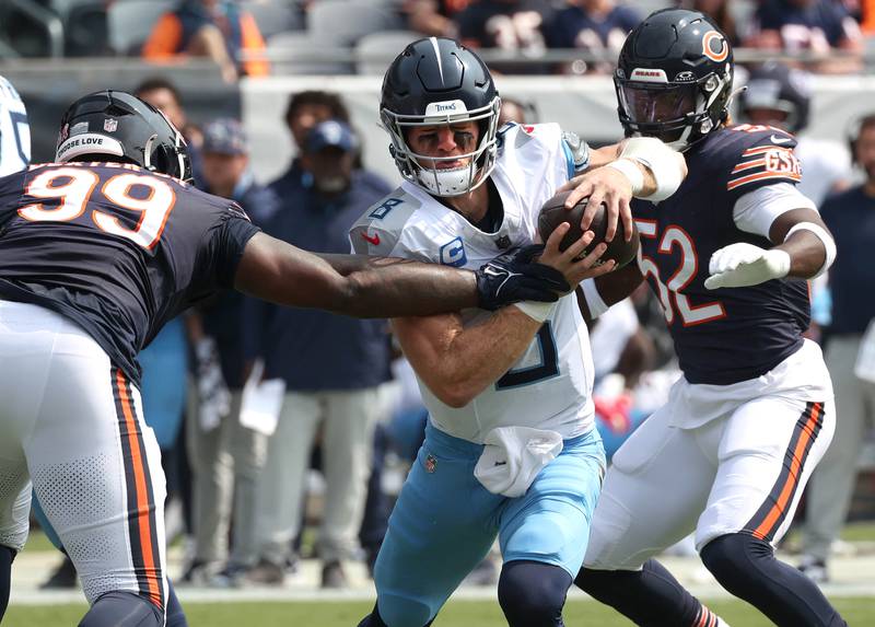 Chicago Bears defensive tackle Gervon Dexter Sr. (left) and defensive end Darrell Taylor help sack Tennessee Titans quarterback Will Levis during their game Sunday, Sept. 8, 2024, at Soldier Field in Chicago.