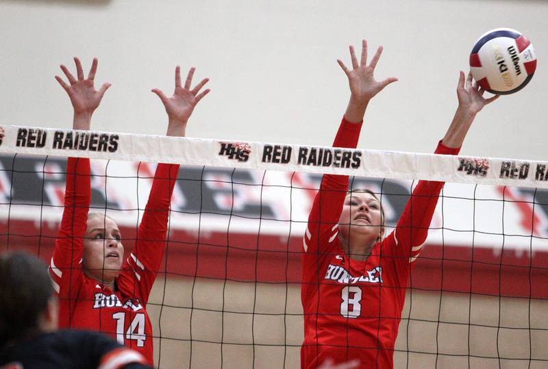 Huntley’s Julia Lesniak, left, and Summer Massow block against Crystal Lake Central during a Fox Valley Conference volleyball match on Tuesday, Aug. 27, 2024, at Huntley High School.