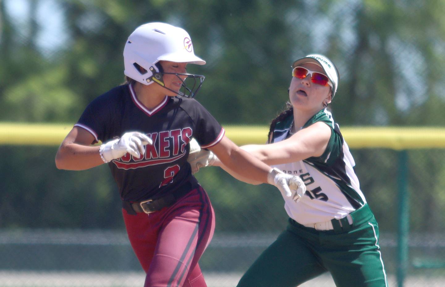 Richmond-Burton’s Adriana Portera, left, is tagged out on a rundown by North Boone’s Sydney Goodman during Class 2A softball sectional final action at Marengo Saturday.