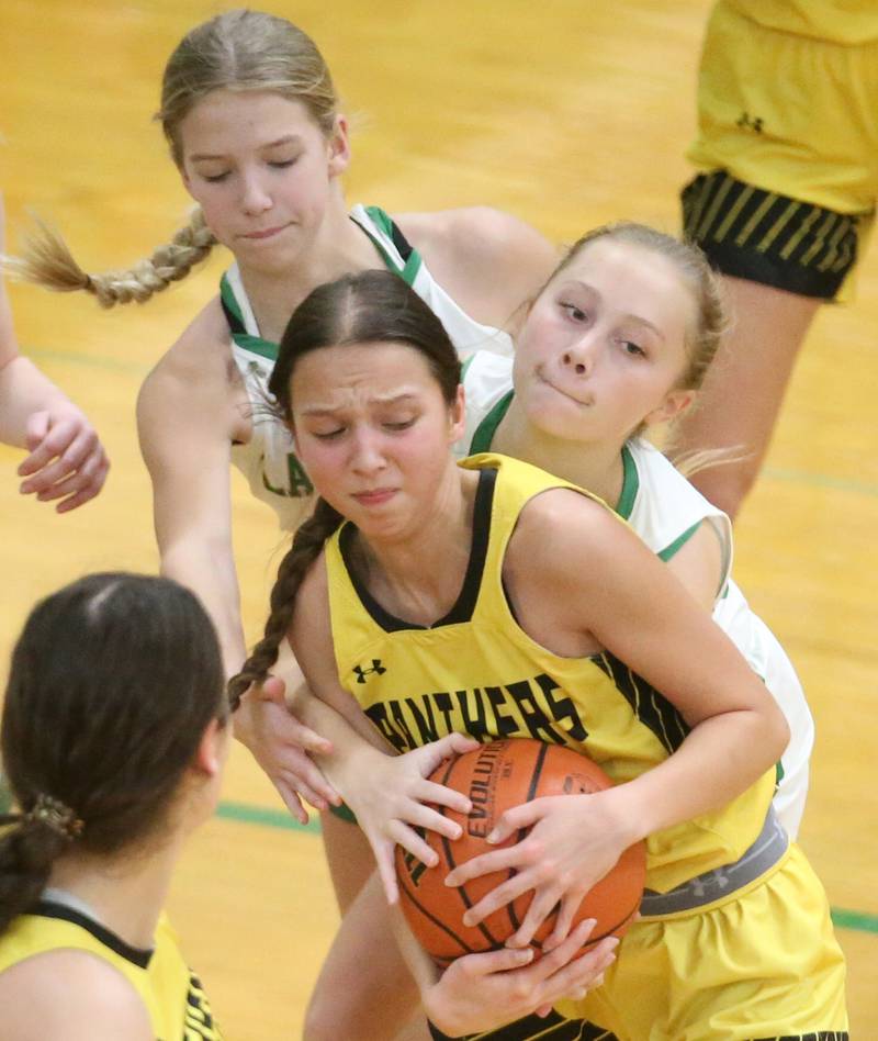 Putnam County's Eme Bouxsein grabs a rebound as Seneca's Lauryn Barla defends from behind and forces a jump ball on Thursday, Jan. 4, 2024 at Seneca High School.