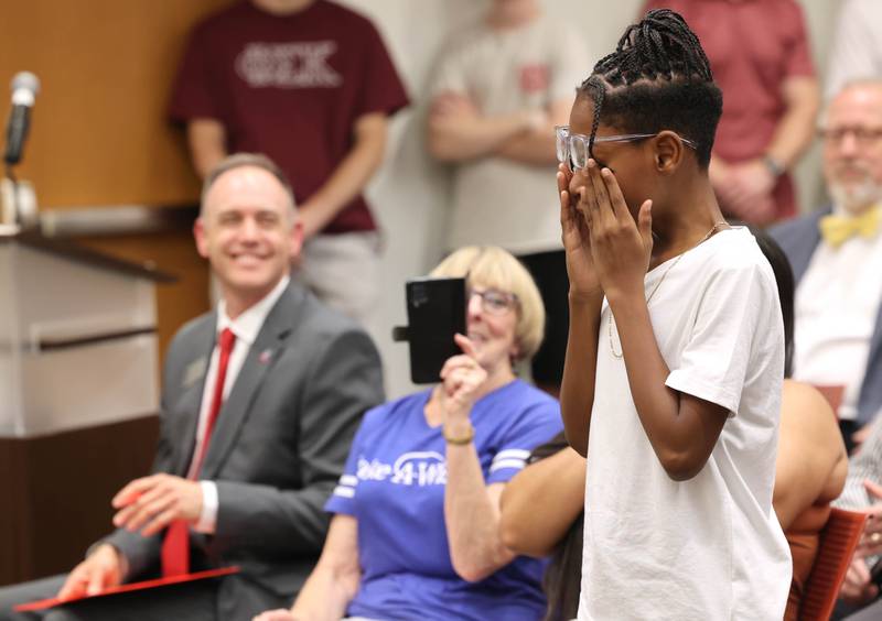 Elijah Livingston reacts after learning his wish was granted by Make-A-Wish Illinois Monday, July 10, 2023, during the DeKalb City Council meeting. Livingston also received a key to the city from Mayor Cohen Barnes.