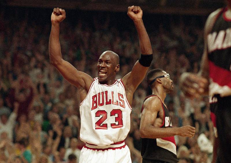 FILE - In this June 14, 1992, file photo, Michael Jordan celebrates the Bulls win over the Portland Trail Blazers in the NBA Finals in Chicago. Decades after Jordan's groundbreaking departure from college, March Madness and the NBA's mega-millions have taken all the novelty out of leaving early for the pros. (AP Photo/John Swart, File)