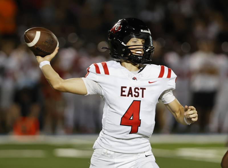 Glenbard East's Michael Nee (4) drops back to pass during the varsity football game between Glenbard East and Willowbrook high schools on Friday, Sep. 30, 2024 in Villa Park.