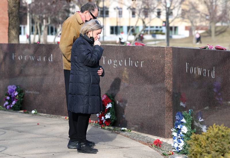 Visitors pay their respects Wednesday, Feb. 14, 2024, during a ceremony in the Peaceful Reflection Garden near Cole Hall at Northern Illinois University honoring the victims of the 2008 shooting on campus in DeKalb. Wednesday marked 16 years since the deadly shooting took place at NIU which took the lives of five people.