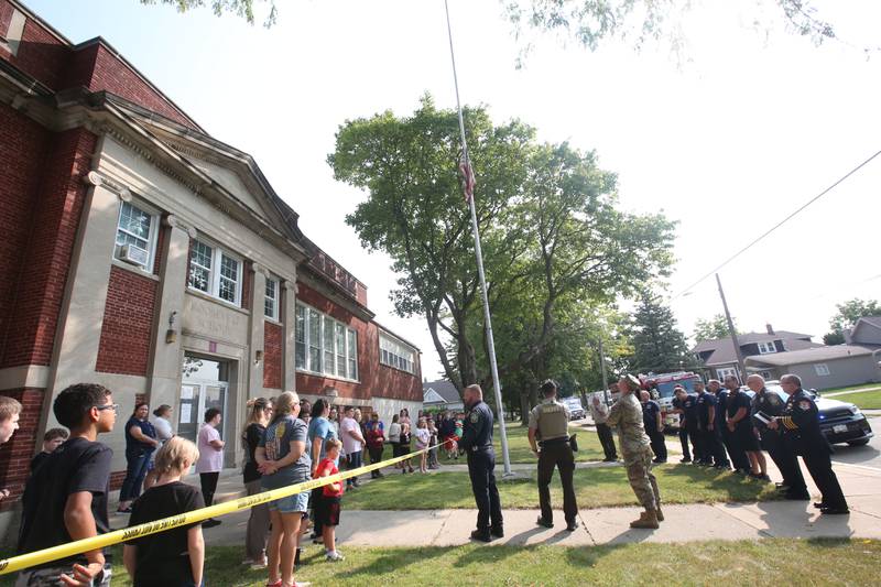 Students watch an American Flag being raised during a 9/11 Memorial Service on Wednesday, Sept. 11, 2024 at Circuit Breaker School in Peru. Firefighters police officers and paramedics from La Salle, Peru, and Hennepin participated in the memorial service.