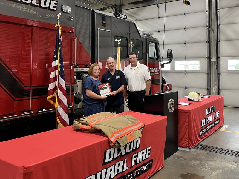 Amy Kutz (left), a registered nurse at CGH Medical Center, was the first civilian to be presented with Dixon Rural Fire Protection districts Lifesaving Award by Chief Dustin Dahlstrom (right). Kutz performed CPR on an unresponsive 3 year old who almost drowned.