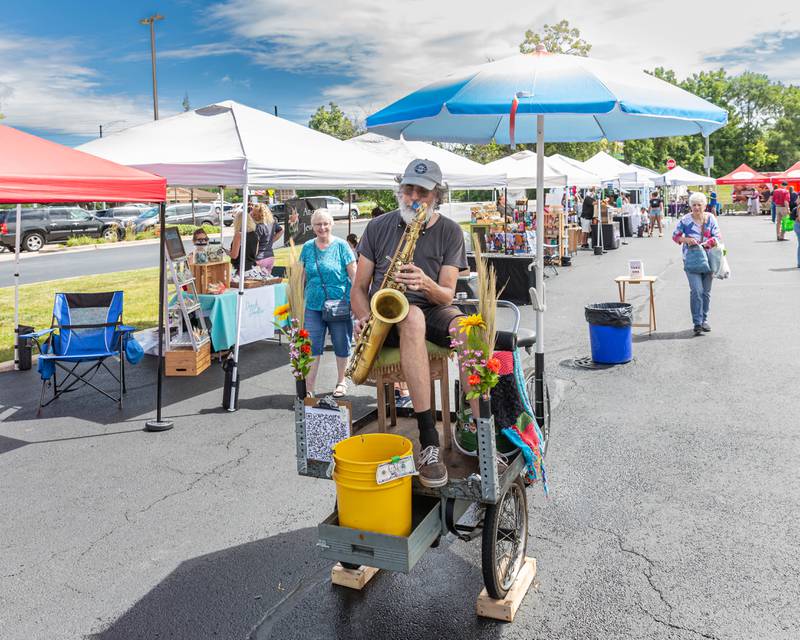 A saxophone musician performs at the Winfield Farmer's Market in Winfield, IL.  July 3rd, 2024.