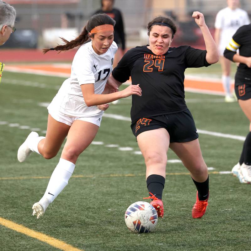 DeKalb’s Alexia Ortiz kicks the ball away from Belvidere North's Isabella Phommachanh during their game Tuesday, March 12, 2024, at DeKalb High School.