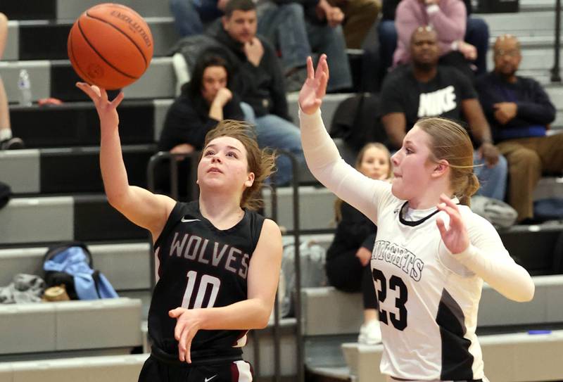 Prairie Ridge's Ali Storz gets a layup in front of Kaneland's Kendra Brown Thursday, Feb 15, 2024, during their Class 3A regional final game at Kaneland High School in Maple Park.