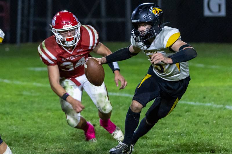 Kolton Kruse of Riverdale runs ball whilst Aiden Redcliff of Hall trails behind him on Friday, October 18, 2024 at Richard Nesti Stadium in Spring Valley.