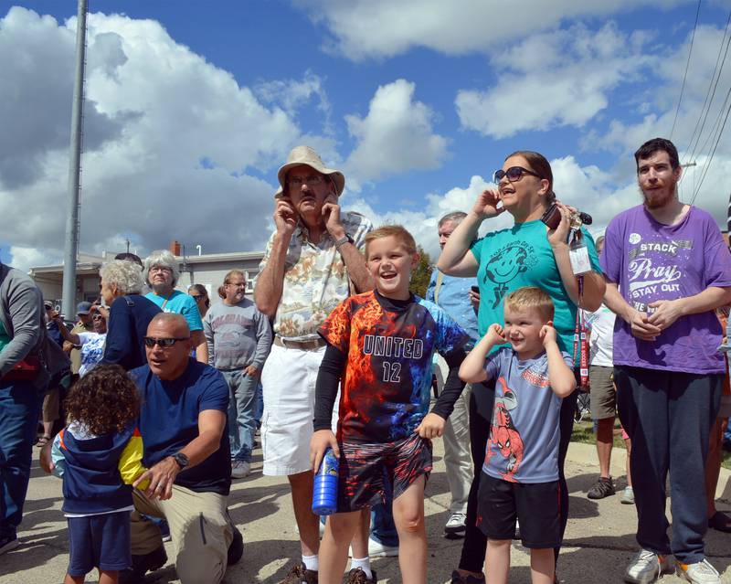 Sebastian Saffell, 6, (Spider-Man shirt) plugs his ears while he, Spencer Saffell, 9, (United 12 shirt) and Beth Saffell, of Sterling, watch as the Union Pacific Big Boy Steam Engine No. 4014 arrives at its whistle stop on Friday, Sept. 6, 2024, at the Sterling Marketplace.