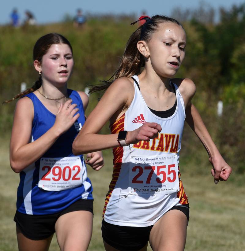 Batavia’s Gwendolyn Krodel, right, finishes in third place, just ahead of St. Francis’ Elena Mamminga during the Kane County cross country invite on Saturday, Aug. 31, 2024 in Geneva.