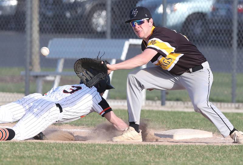 Metea Valley's Drew Hopkins takes the throw as they try to pickoff DeKalb's Nik Nelson  during their game Thursday, April 13, 2023, at DeKalb High School.