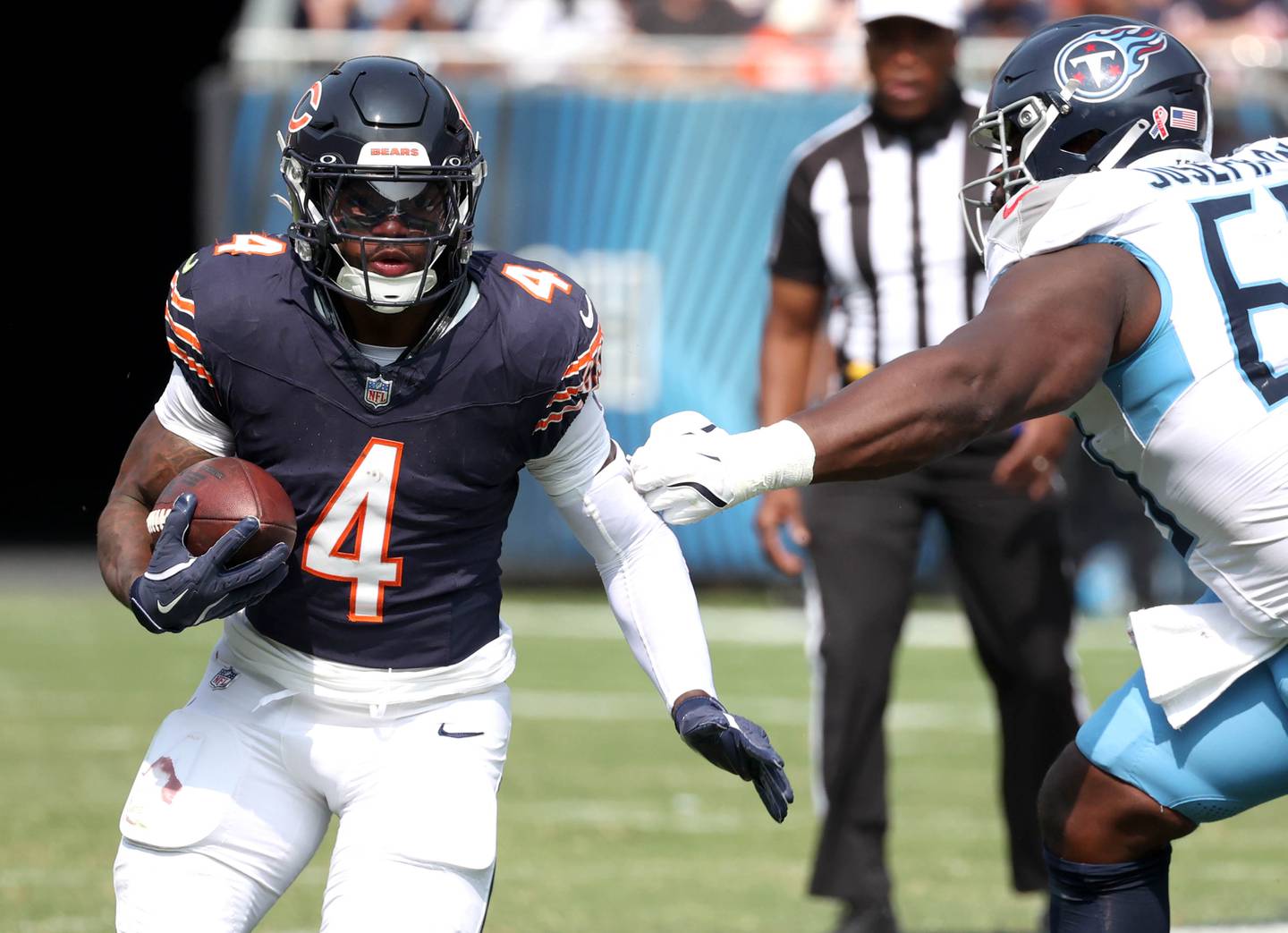 Chicago Bears running back D'Andre Swift runs past the outstretched arm of Tennessee Titans defensive tackle Sebastian Joseph-Day during their game Sunday, Sept. 8, 2024, at Soldier Field in Chicago.