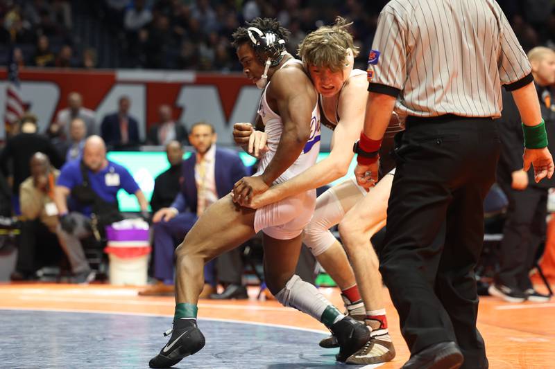 Warren’s Aaron Stewart escapes Mount Carmel’s Edmund Enright for a decisive point in the 157-pound Class 3A state championship match on Saturday, Feb. 17th, 2024 in Champaign.
