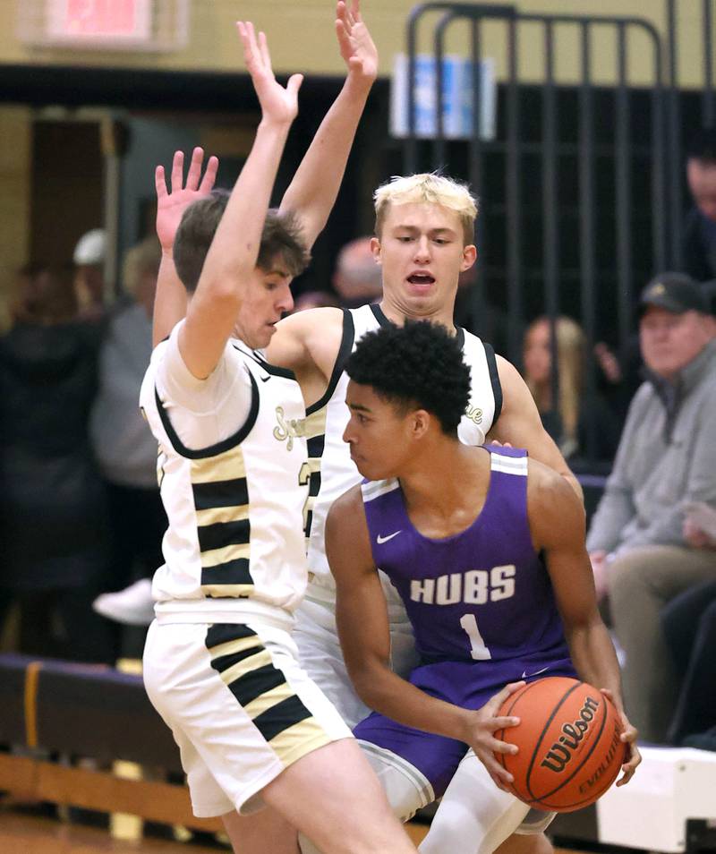 Sycamore's Ben Larry (left) and Carter York trap Rochelle's Cayden Moore during their game Tuesday, Dec. 5, 2023, at Sycamore High School.