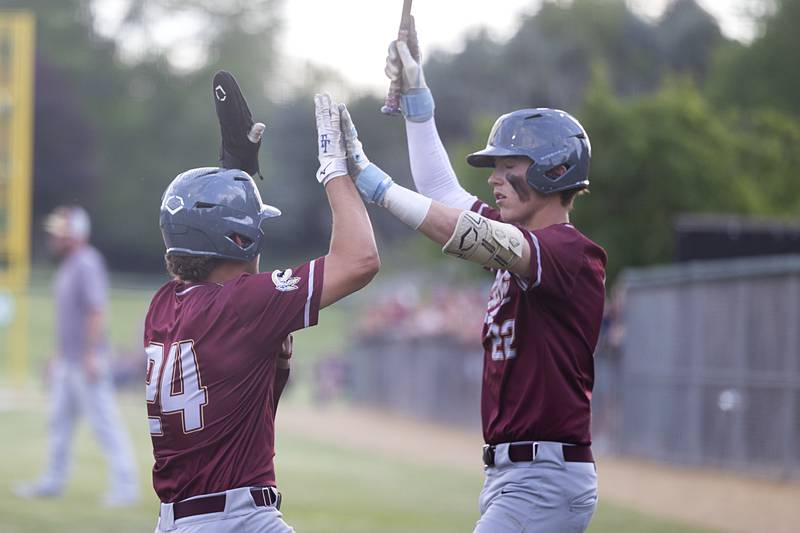 Morris’ Colin Pfeifer (left) and Brett Bounds celebrate a score against Sycamore Monday, June 3, 2024 in the Class 3A Geneseo supersectional.