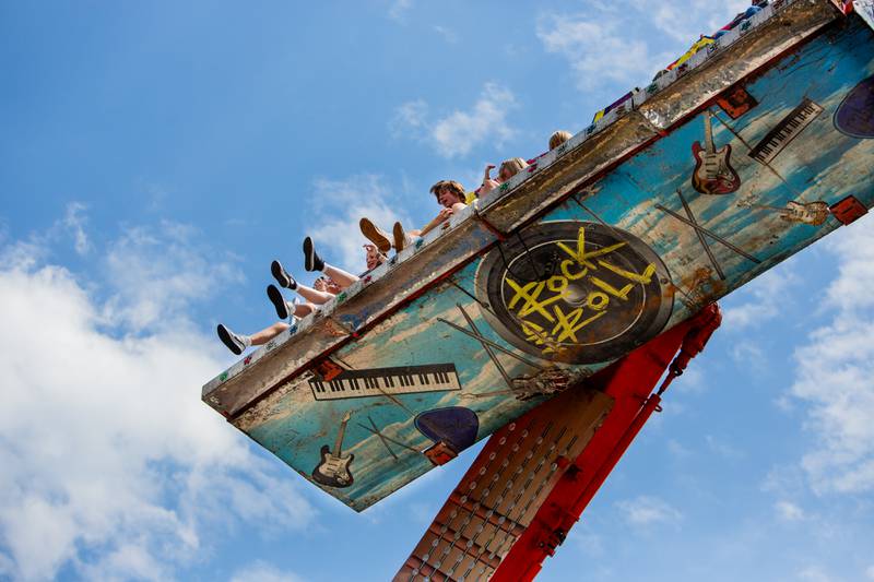 The feet of teens and children hang over the Rock and Roll ride during the Downer’s Grove Rotary Fest, Saturday, June 22, 2024.

Suzanne Tennant/For Shaw Local News Media