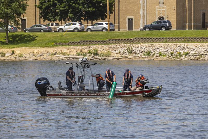 The first of six sets of buoys are placed in the Rock River by Dixon Rural firefighters Thursday, May 23, 2024. This is the first time the departments have placed the markers.