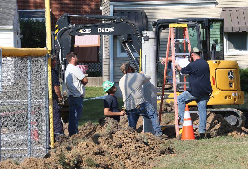 Crews work on replacing lighting at Sunset Park on Wednesday, Sept. 18, 2024 in Peru.