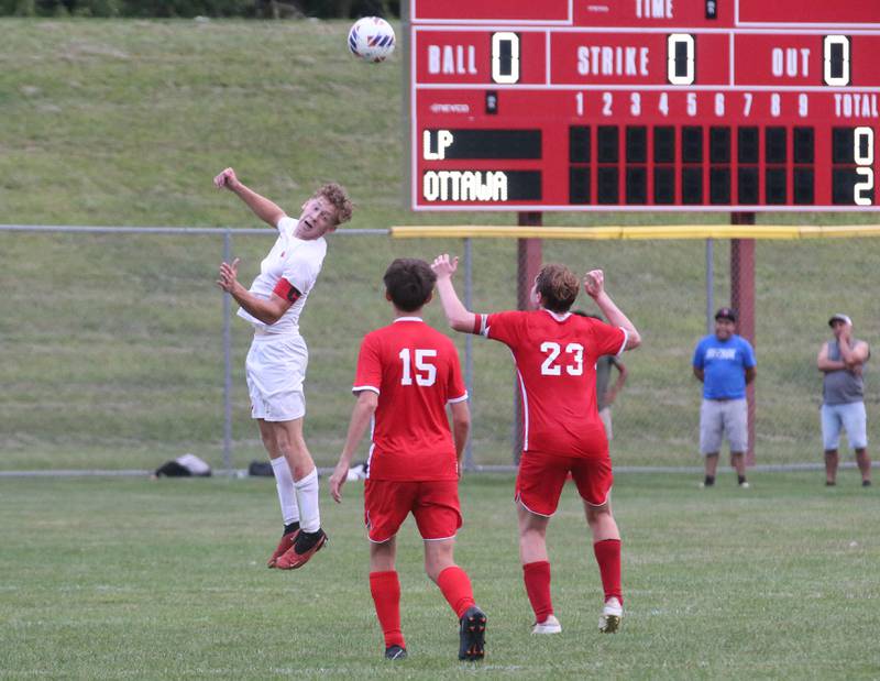 L-P's Jason Curran puts a header on the ball as Ottawa's Joran Arroyo and Evan Snook look on during the game on Thursday, Sept. 5, 2024 at King Field.