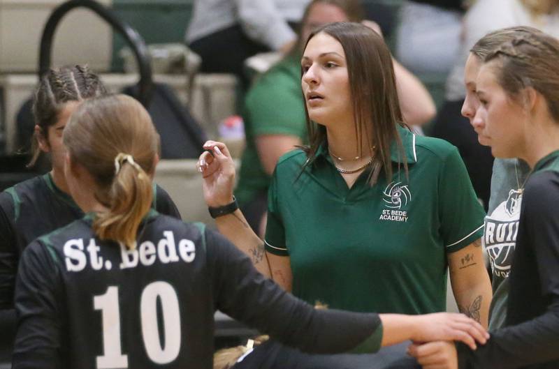 Bureau Valley head volleyball coach Kaitlyn Edgcomb talks to her team during a time out while facing Bureau Valley on Monday, Sept. 9, 2024 at St. Bede Academy.