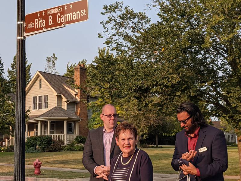 During a Sept. 9 ceremony, Garfield Street in Oswego was dedicated to retired Illinois Supreme Court Justice Rita Garman, center. Oswego Village President Ryan Kauffman, far left, and Oswego Historic Preservation Commission Chairman Subash George, far right, were part of the ceremony.