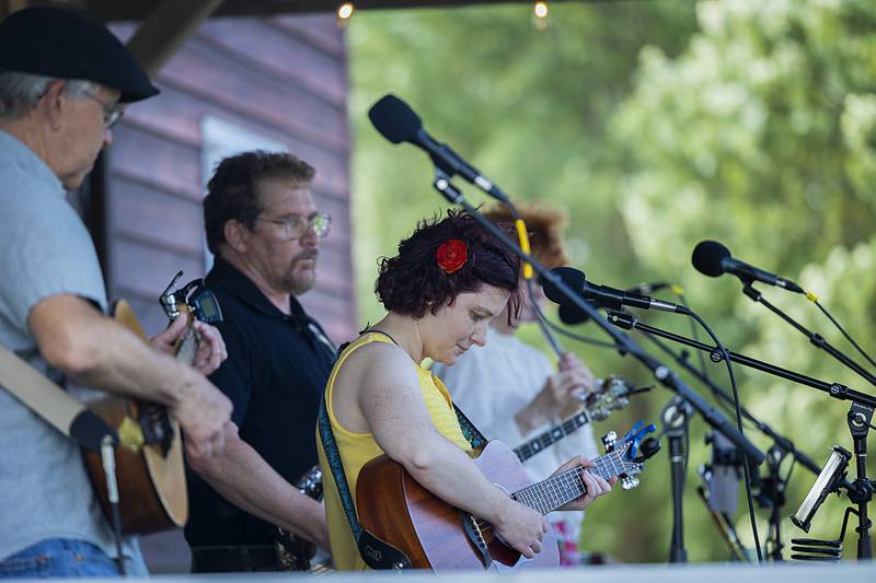 Members of Turas, a traditional Irish music band from Peoria, entertains a crowd Saturday, June 22, 2024 outside of the Grist Mill in Franklin Creek State Park. Park leaders hosted a fundraiser in conjunction with the summer solstice with music and food.