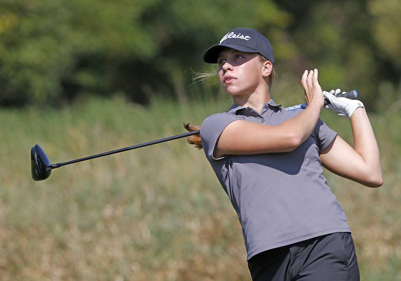 Jacobs’ Natalie Zimmerman watches her tee shot on the 6th hole of the Valley course during the McHenry County Tournament on Thursday, Sept.12, 2024, at Boone Creek Golf Club in Bull Valley.