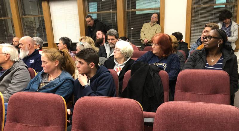 Community members attend a Woodstock City Council meeting Tuesday, Jan. 2, at which the council approved an ordinance to deter buses that drop off migrants.