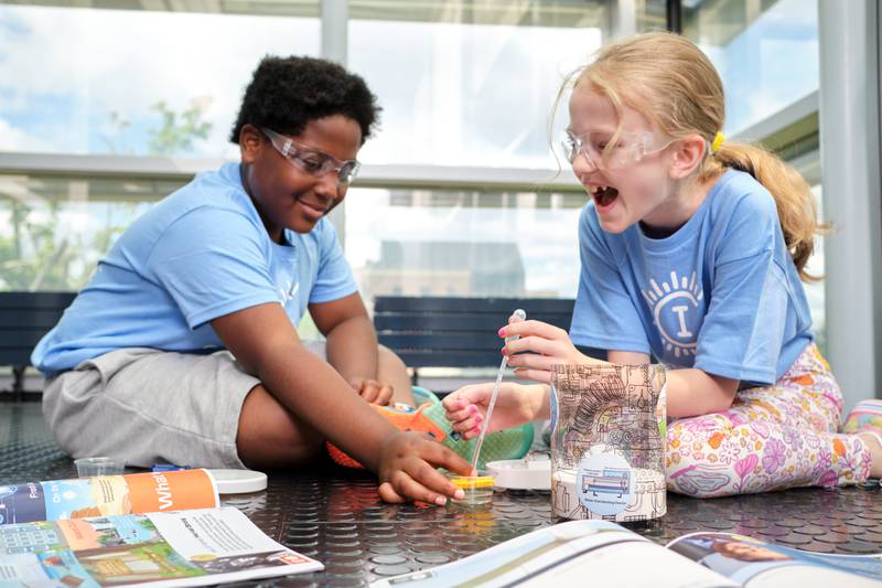 Two children experience the HydroDrop activity at Camp Invention. Camp Invention will come to Yorkville the week of July 8 to July 12.