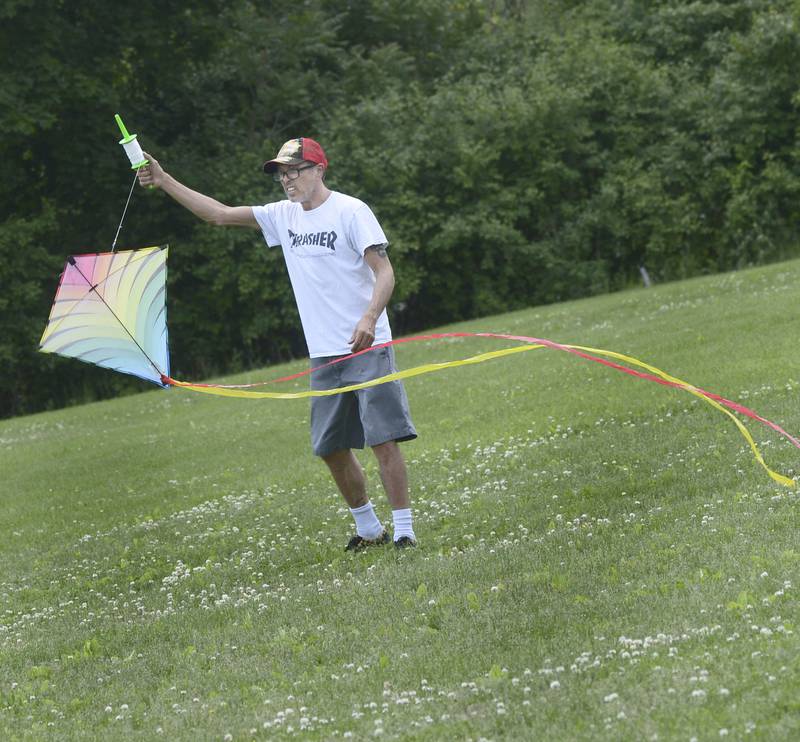 Scott Coley looks for some wind to get his kite airborne during Kites in Flight at Ottawa’s Riverfront Saturday.