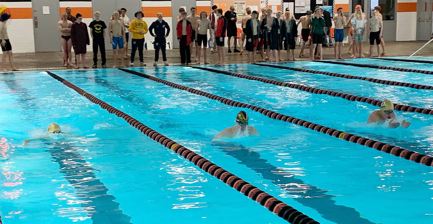 Sterling seniors Connor Pham (left) and Evan Scott (right) swim in the 100-yard breaststroke against Dunlap's Connor Devanna at the United Township Sectional on Saturday, Feb. 18, 2023 in East Moline.