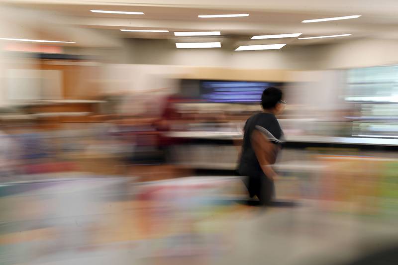 A student hurries though the renovated library learning center at Johnson Elementary School Wednesday August 16, 2023 in Warrenville.