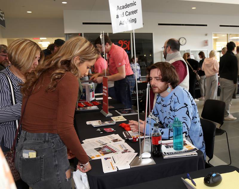 Sheyla Arreguin of Plano asks questions to Peer Support Leader Jacob Skokna at the Waubonsee Community College Transfer and Career Open House at the Sugar Grove Campus on April 20, 2024.