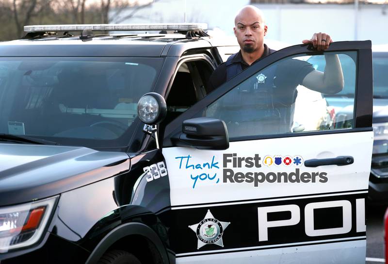 DeKalb Police Officer Justin Hickman by a patrol vehicle Friday, April 19, 2024, outside the DeKalb Police Department.