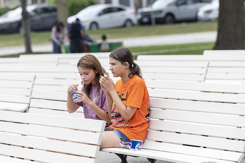 Maddy Zigler (left), 12, of Sterling and Olivia Riddle, 12, of Rock Falls enjoy some snacks Saturday, June 22, 2024 during Sterling’s Juneteenth celebration. The Sauk Valley Diversity Alliance hosted the event at Grandon Civic Center.