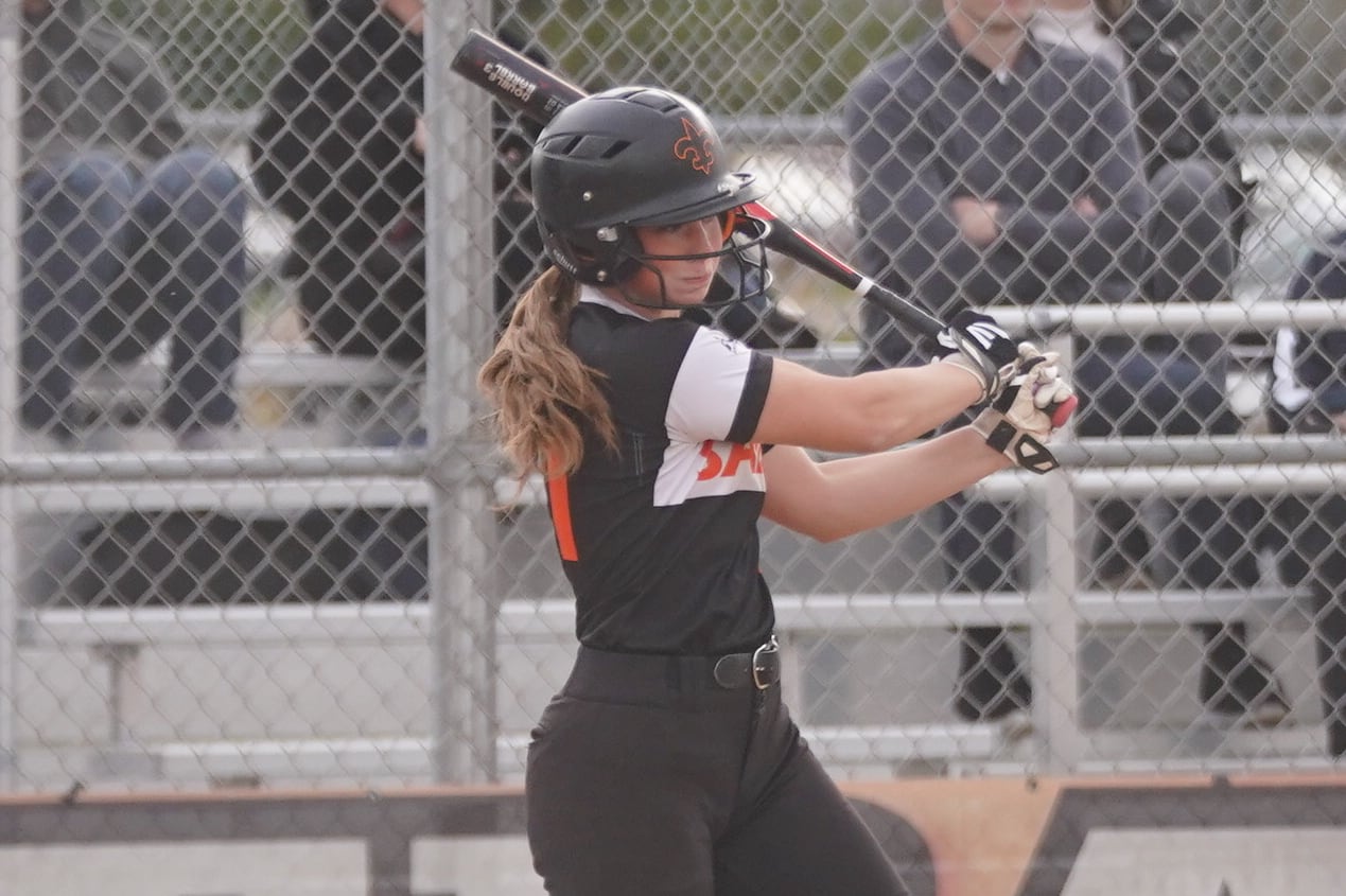 St. Charles East's Sam Gaca (11) singles against Downers Grove South during a softball game at St. Charles East High School on Wednesday, April 10, 2024.