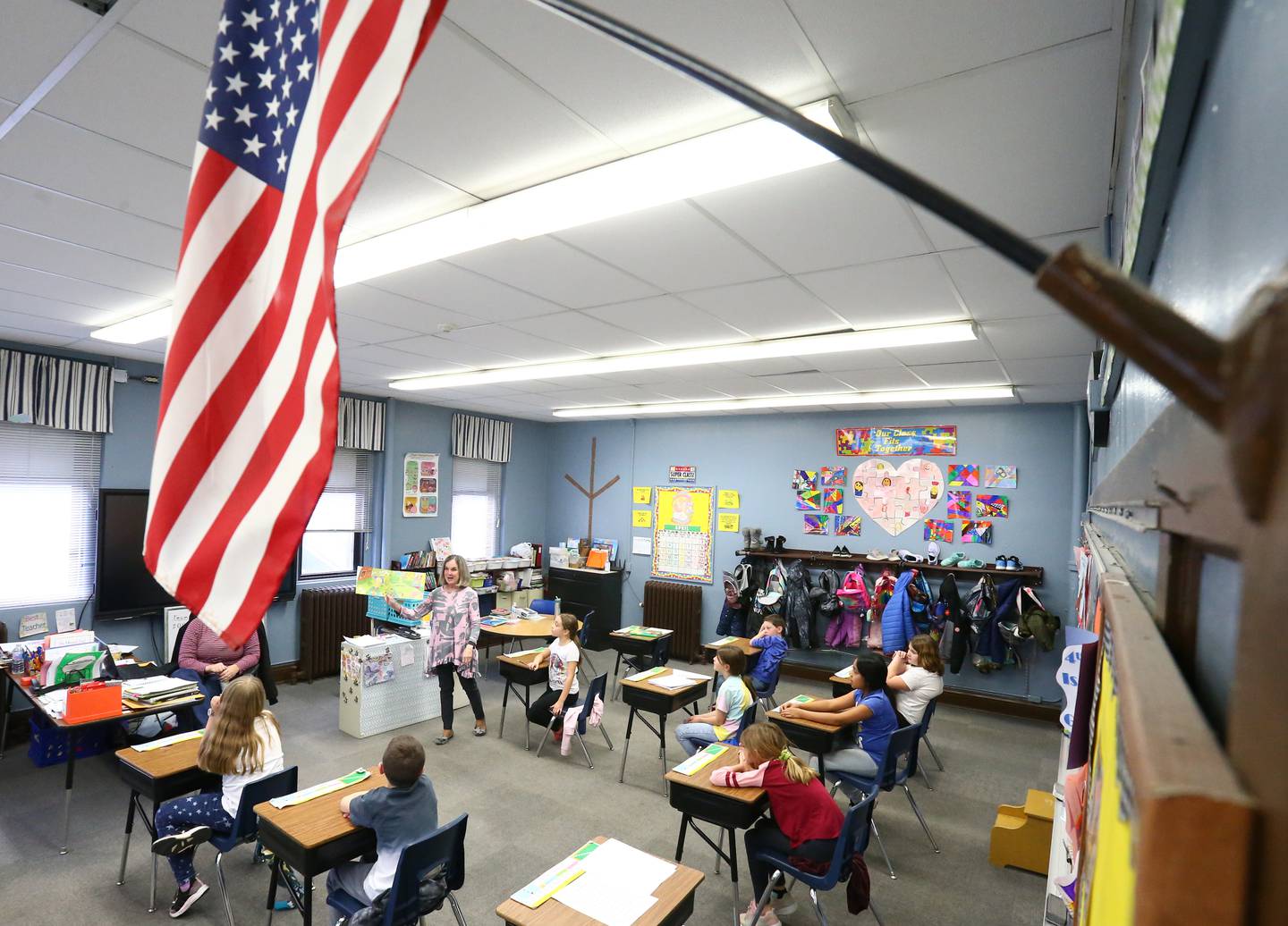 Sharon Lamps, third and fourth grade teacher at Dalzell Grade School, reads a book to her class called "April Foolishness" on Thursday March 31, 2022. Lamps has been teaching for 35 years and currently teaches part time at the school on Tuesdays and Thursdays.