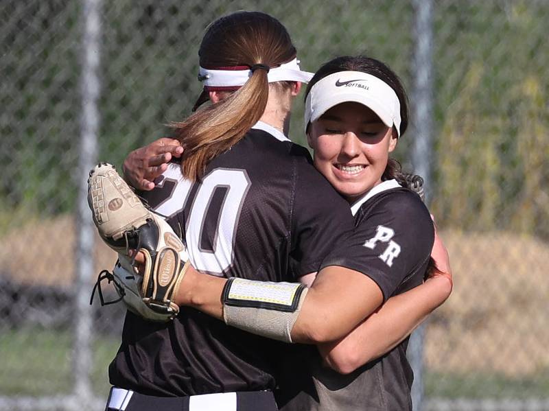 Prairie Ridge's Kylie Carroll (left) gets a hug after making a diving catch from teammate Emily Harlow during their Class 3A sectional semifinal game against Sterling Wednesday, May 29, 2024, at Sycamore High School.