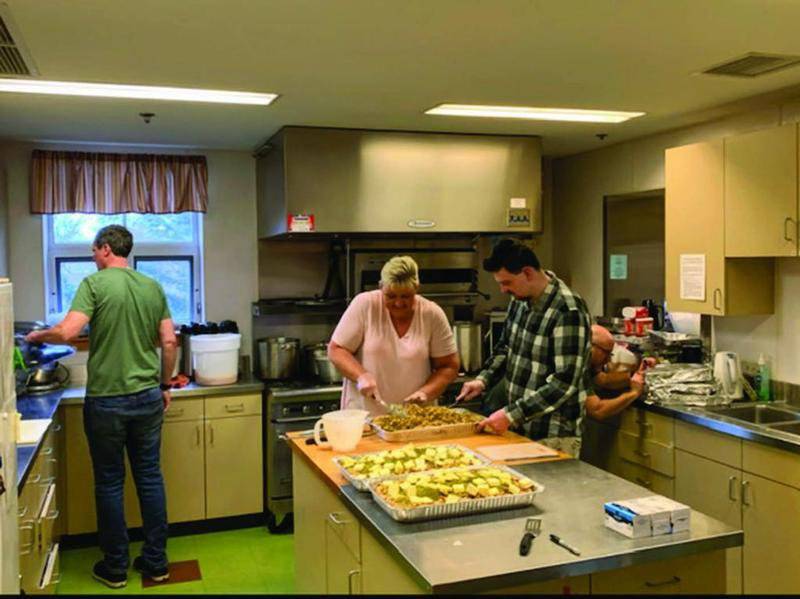 Volunteers at St. Andrew’s Episcopal Church in Downers Grove prepare a meal for Thanksgiving. This year, the church will prepare a similar meal on Christmas Eve and expects to distribute food to more than 300 people. Photo provided