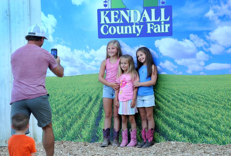 Nine-year-old Blake West of Yorkville and her friends from Maryland, Olivia Sibenaller, 5 and sister Charlotte, 9 have their picture taken during the Kendall County Fair in Yorkville on Thursday, Aug. 3, 2023.