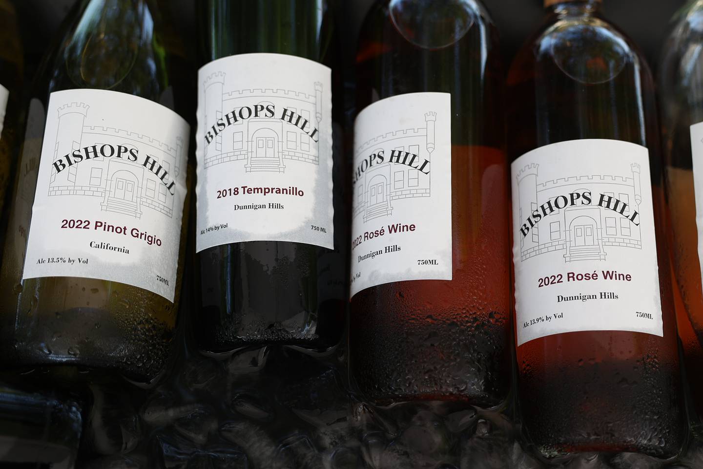 Bottles of wine sit in an ice bath at the Bishops Hill table of Joliet at the Wine, Jazz and Arts Fest at Bicentennial Park in Joliet on Saturday, Aug. 19, 2023.