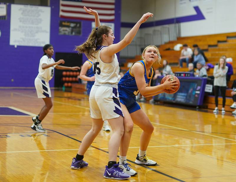 Johnsburg's Sophie Person (31) posts up against Plano's Chloe Rowe (15) during a basketball game at Plano High School on Tuesday, Jan 30, 2024.