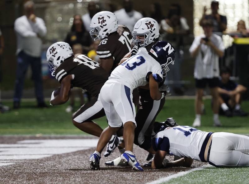 Mt. Carmel's Danyi Taylor Jr. (10) crosses the goal line during the varsity football game between Nazareth Academy and Mt. Carmel high school on Friday, Sep. 13, 2024 in Chicago.