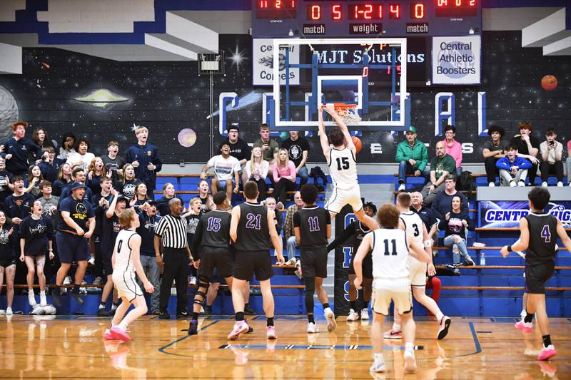 Fieldcrest's Brady Ruestman hits a slam dunk as the fan section goes wild Tuesday during the Knights' 53-37 victory over Manteno in the IHSA Class 2A Clifton Central Sectional semifinal game.
