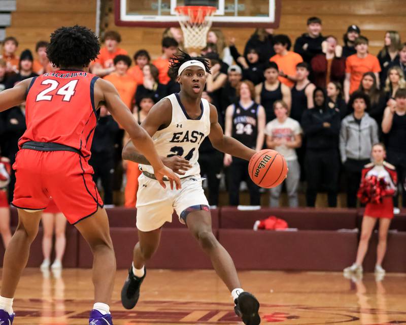 Oswego East's Mekhi Lowery (24) advances the ball during Class 4A Lockport Regional final game between West Aurora at Oswego East.  Feb 24, 2023.